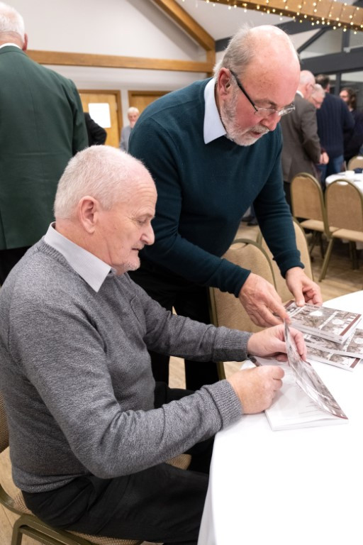 Andrew signing books